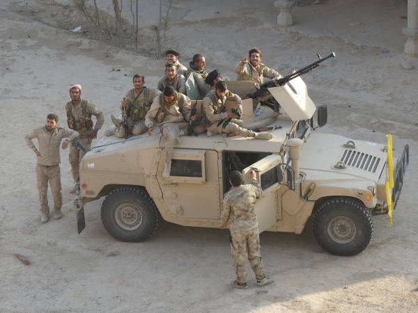 SDF-fighters-stand-atop-Humvee.jpg